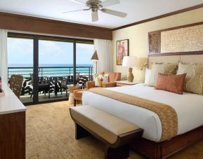 King bed with outdoor terrace at Ko'a Kea Resort On Po`ipu Beach.