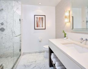 Bathroom with shower at Ko'a Kea Resort On Po`ipu Beach.