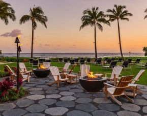 Garden with seating area ideal for coworking at Ko'a Kea Resort On Po`ipu Beach.