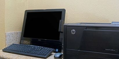 Business center with computer and printer at Travelodge LAX By Wyndham.