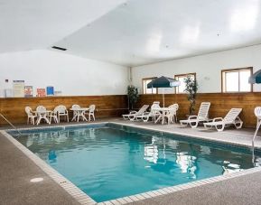 Outdoor pool with lounge chairs at Norwood Inn Minneapolis Roseville.