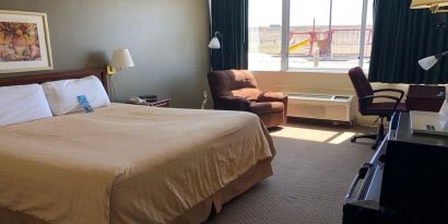 Day use room with work desk and natural light at Norwood Inn & Suites La Crosse.
