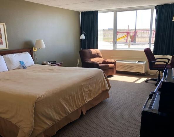 Day use room with work desk and natural light at Norwood Inn & Suites La Crosse.