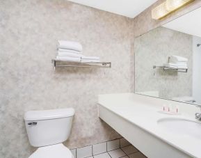 Private guest bathroom with shower and free toiletries at Norwood Inn & Suites La Crosse.