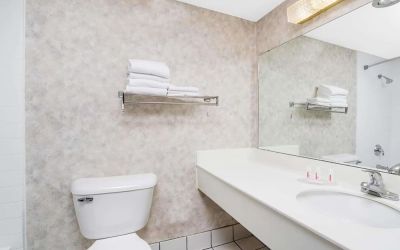 Private guest bathroom with shower and free toiletries at Norwood Inn & Suites La Crosse.