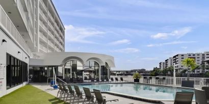 Outdoor pool with lounge chairs at Hotel Tampa Riverwalk.