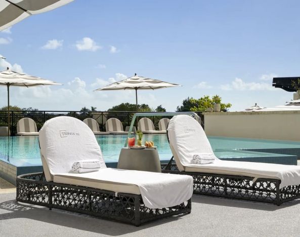 Stunning outdoor pool with sun beds at THesis Hotel Miami.