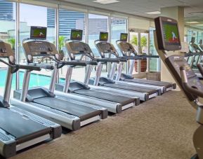 The hotel fitness center has numerous treadmills and other exercise machines, and faces the pool.