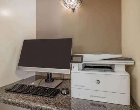 Hotel business center workstation, including monitor, keyboard, mouse, and printer.