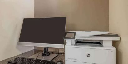 Hotel business center workstation, including monitor, keyboard, mouse, and printer.