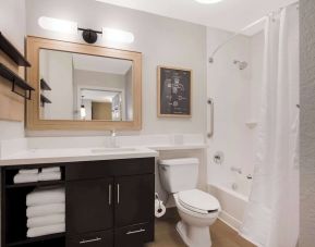 Sonesta Simply Suites Irvine East Foothill guest bathroom, including mirror, lavatory, sink, and bath with a shower.