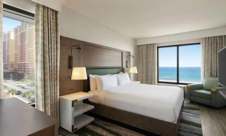 Day use room with king bed and sea view at Embassy Suites By Hilton Panama City Beach Resort.