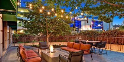 Hotel terrace with lounge seating and fire pit at Hilton Minneapolis.