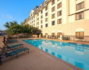 Outdoor pool with lounge chairs at Hilton Garden Inn Houston NW/Willowbrook.