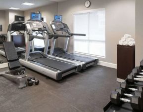 The hotel fitness center is equipped with racks of free weights plus treadmills.