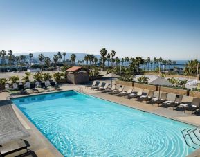 Stunning outdoor pool area with pool chairs at Sonesta Redondo Beach & Marina.