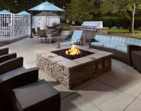 Sonesta ES Suites Cincinnati - Blue Ash’s patio area features a fire pit, plus tables and chairs, and a barbecue.