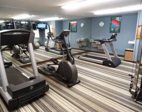 The hotel fitness center has numerous exercise machines, and a widescreen television.