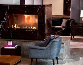 Royal Sonesta Washington DC Dupont Circle’s lobby lounge is furnished with comfortable seating, coffee tables, and a fireplace.