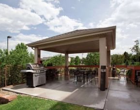 The hotel’s patio offers outdoor tables and chairs under cover, in addition to a barbecue.