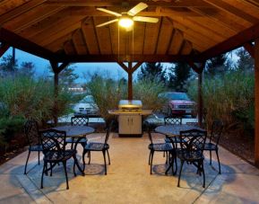 Sonesta Simply Suites Cleveland North Olmsted Airport’s gazebo has an overhead fan, barbecue, and tables and chairs.