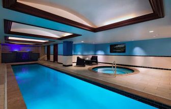 The Stephen F Austin Royal Sonesta Hotel’s narrow indoor pool has two armchairs nearby, plus a hot tub.