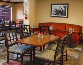 The hotel’s breakfast area has a mix of table sizes and both chairs and sofa seating.