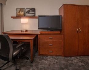 Sonesta Select Arlington Rosslyn guest room workspace, including desk, chair, lamp, and TV.
