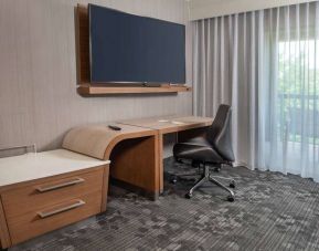 Sonesta Select Allentown Bethlehem Airport guest room workspace, including desk, chair, and huge television.