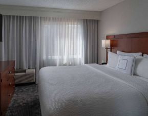 Double bed guest room in Sonesta Select Chattanooga Hamilton Place, including window and widescreen television.