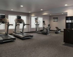 The hotel fitness center has an assortment of exercise machines and free weights.