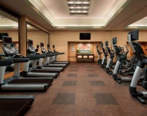 Royal Sonesta Kaua'i Resort Lihue’s fitness center has a large number of exercise machines and a wall-mounted widescreen television.