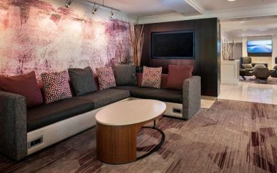 The hotel’s lobby has comfortable sofa seating, a coffee table, and large widescreen television.
