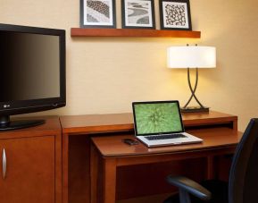 Sonesta Select Boston Danvers guest room workspace, including desk, chair, lamp, and TV.