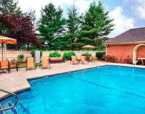 Sonesta Select Boston Danvers’ outdoor pool has sun loungers by the side, in addition to shaded tables and chairs.
