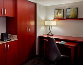 Sonesta Select Atlanta Cumberland Galleria guest room workspace, including desk, chair, and lamp.