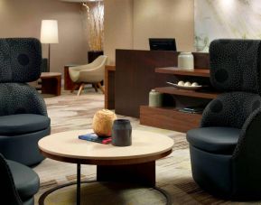 Sonesta Select Atlanta Cumberland Galleria’s lobby lounge is furnished with comfortable chairs and coffee tables.