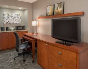 Sonesta Select Seattle Bellevue Redmond guest room workspace, featuring desk and chair, plus TV.