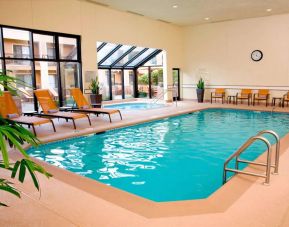 Sonesta Select Seattle Bellevue Redmond’s indoor pool has an adjacent hot tub and nearby loungers and chairs.