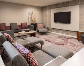 The lobby in Sonesta Select Seattle Bellevue Redmond features an enormous television, comfortable seating and coffee tables.