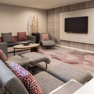 The lobby in Sonesta Select Seattle Bellevue Redmond features an enormous television, comfortable seating and coffee tables.