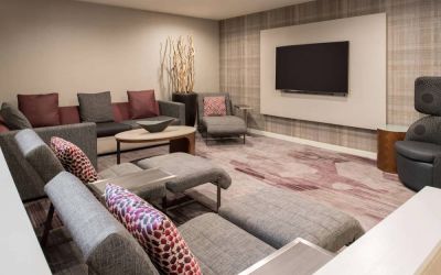 The lobby in Sonesta Select Seattle Bellevue Redmond features an enormous television, comfortable seating and coffee tables.