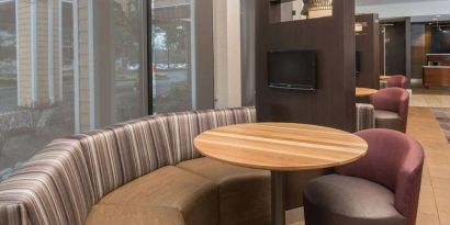 The hotel’s media pods offer a cozy setting for socializing or work, and each has a coffee table and TV.