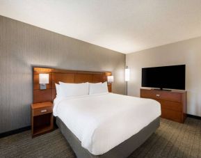 Sonesta Select San Jose Airport double bed guest room, including a large widescreen television.