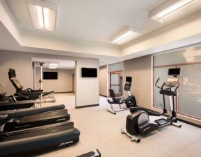 Sonesta Select San Jose Airport’s fitness center is equipped with a range of exercise machines and a wall-mounted TV.