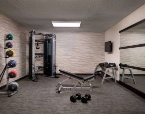 Sonesta Select Charlotte University Research Park’s fitness center is equipped with free weights, a bench, wall-mounted TV, and gym balls.