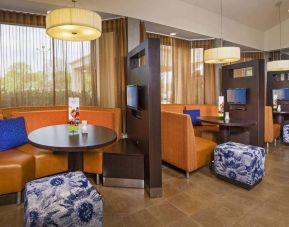 The hotel’s meeting pods provide comfortable seating with televisions and coffee tables for guests to socialize and work.