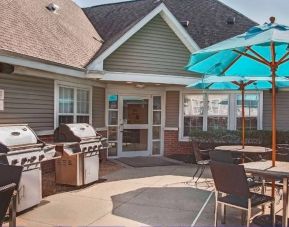 The hotel’s patio area includes shaded tables and chairs, as well as multiple barbecues.