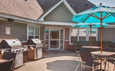 The hotel’s patio area includes shaded tables and chairs, as well as multiple barbecues.