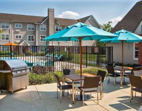 The hotel’s patio has shaded tables and chairs next to a barbecue, with the swimming pool only steps away.